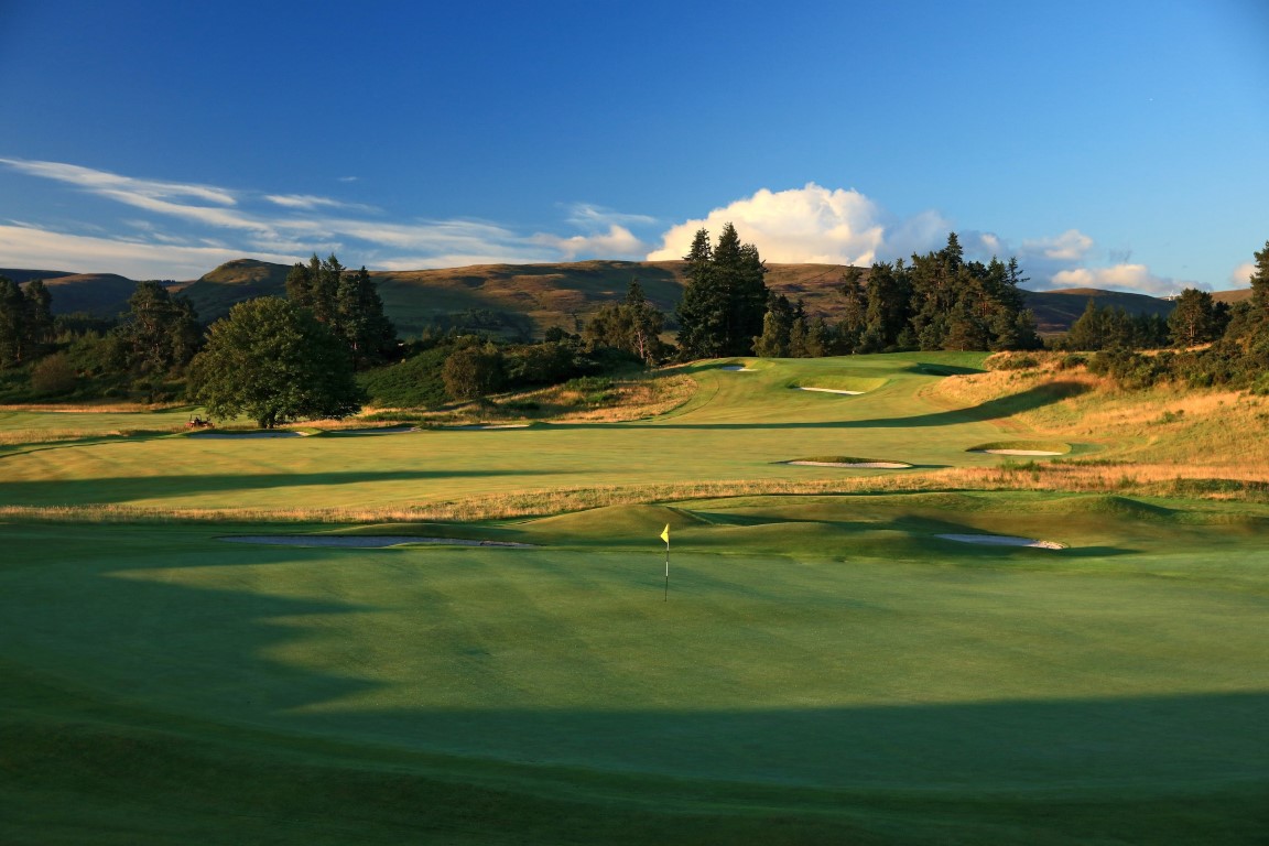 Looking across the 18th green of The King's Course, with the 1st fairway and green beyond.